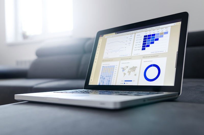 Laptop displaying a data analytics dashboard with classification metrics, geographic distribution, and compliance trend charts